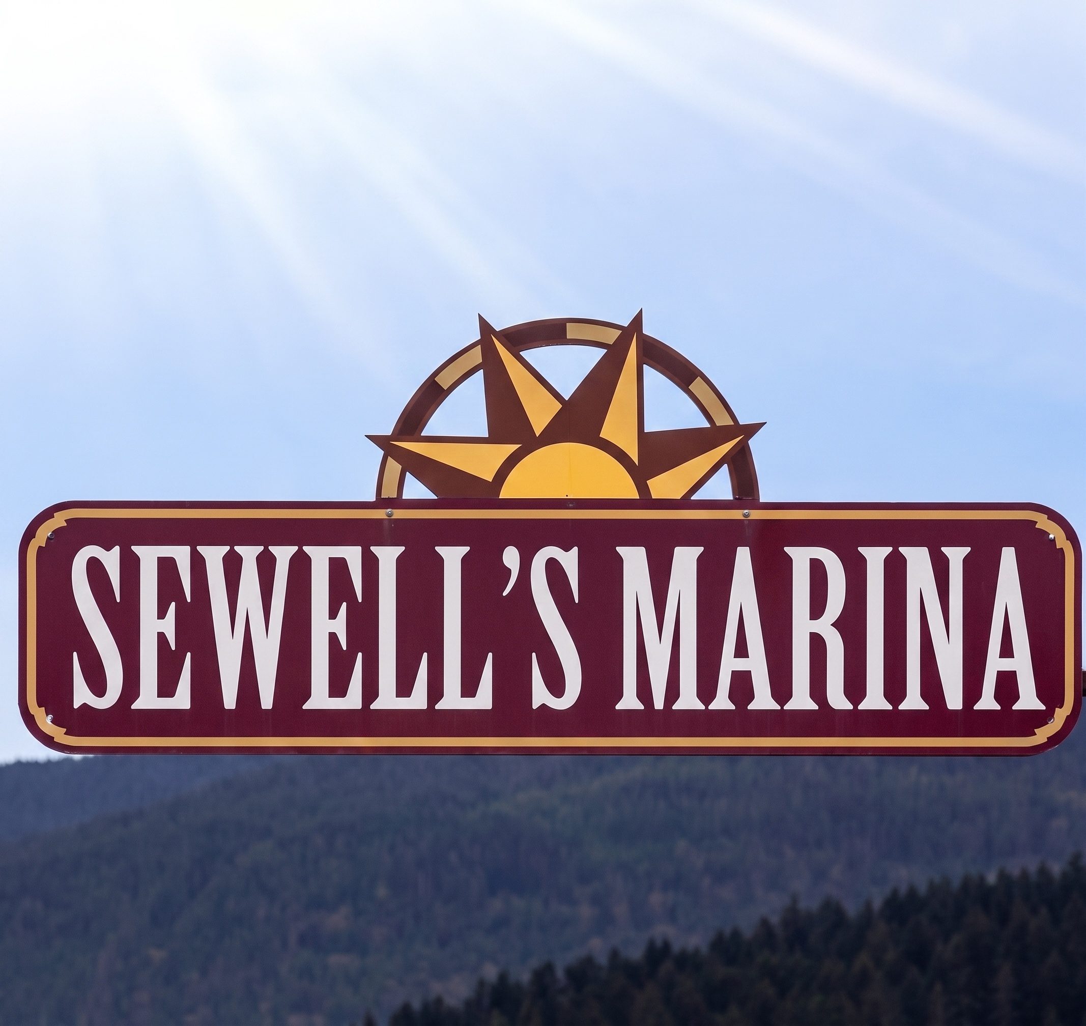 Sewell's Marina sign with sun emblem