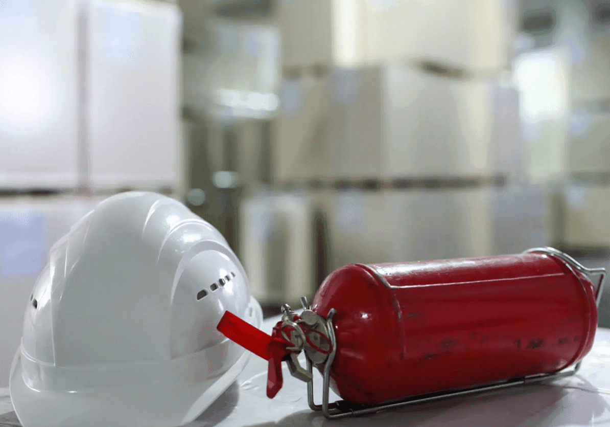 Hard hat and fire extinguisher in warehouse