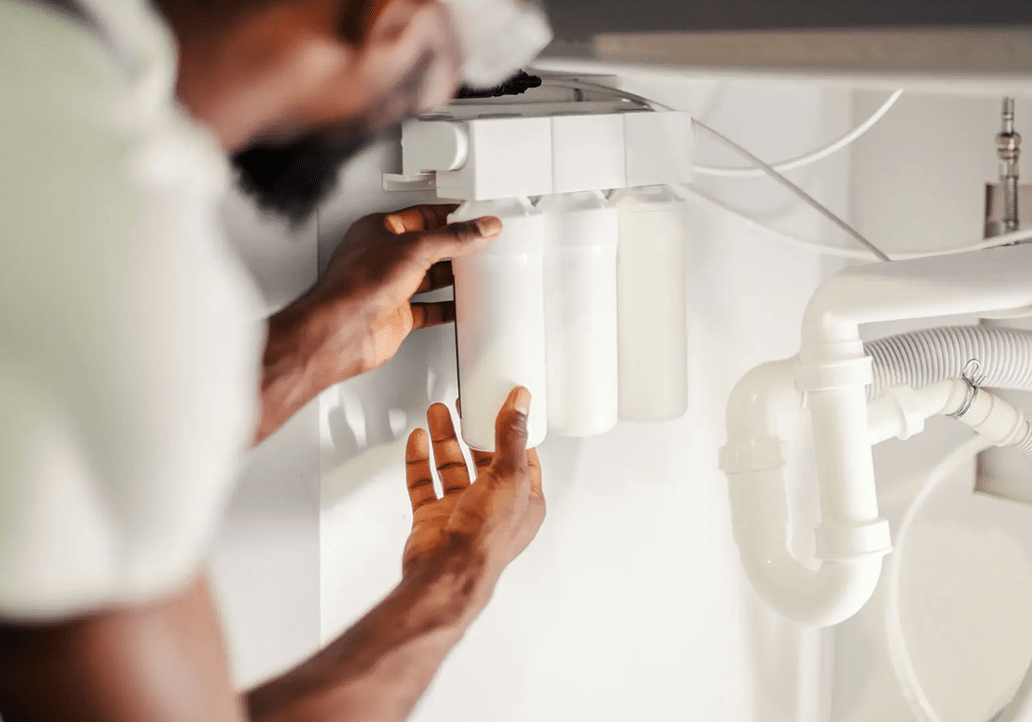 Man fixing kitchen plumbing system
